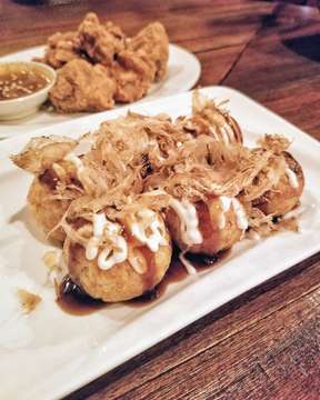 takoyaki. traditional japanese snacks filled with octopus. usually topped off with sweet sauce and dried bonito.